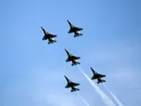 A photo of 5 fighter jets in the sky