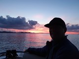 A photo of Peter with a sunset behind him, Aaron Wallis Sales Recruitment